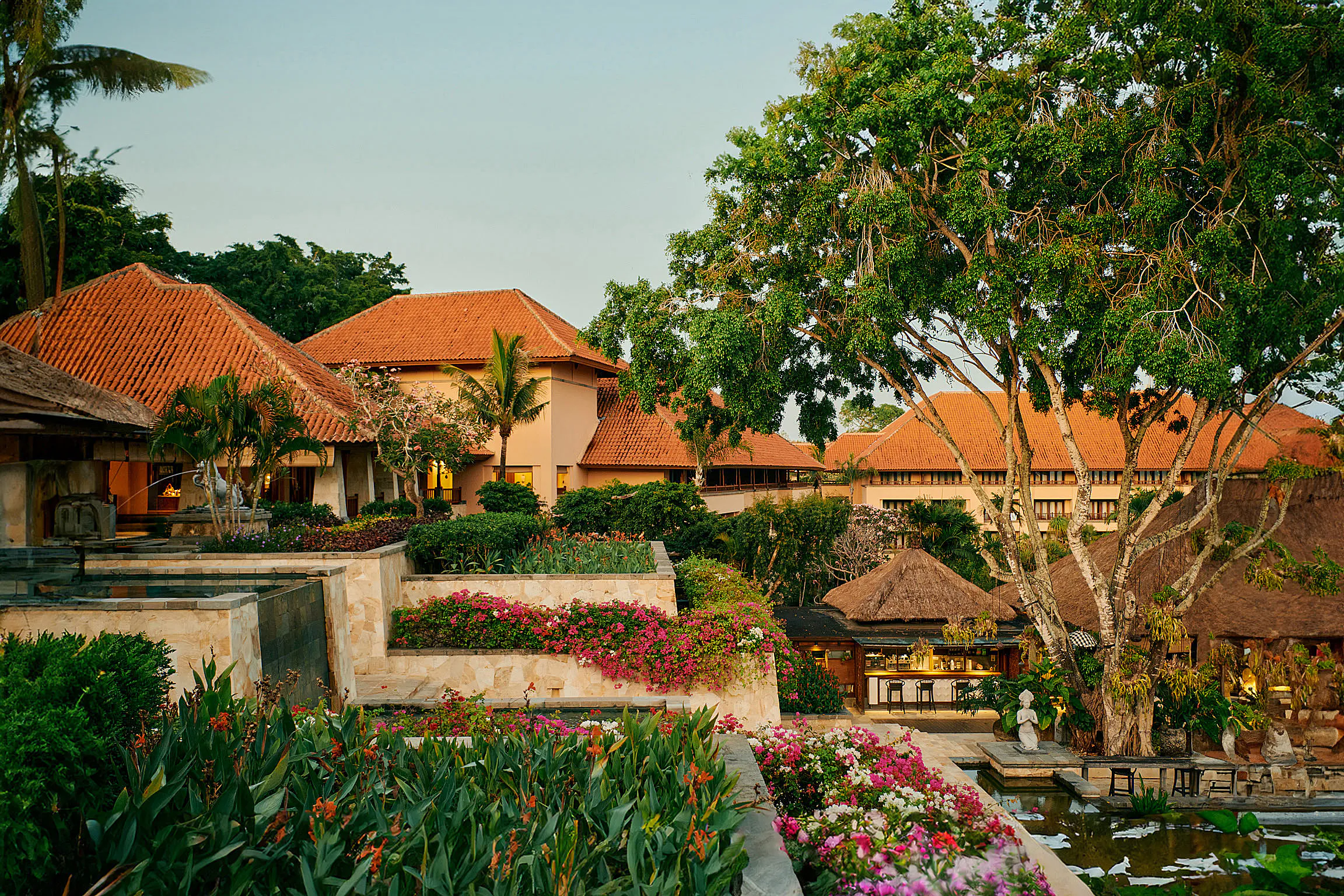 AYANA Resort Bali — poolside daybeds and parasols