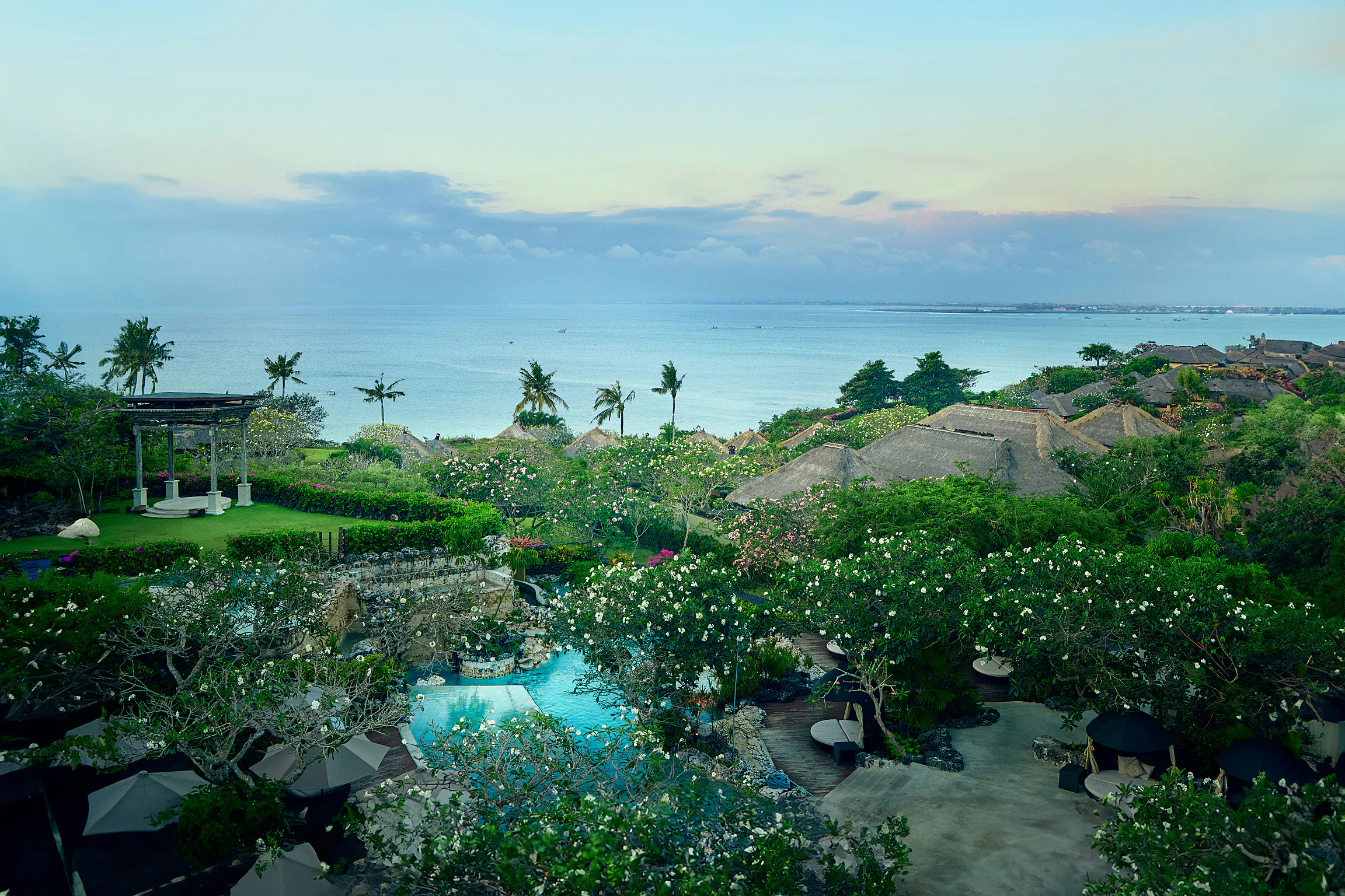AYANA Villas Bali — private pool villa framed by frangipani trees